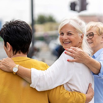 Group of friends smiling while walking together