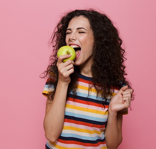 Someone eating an apple