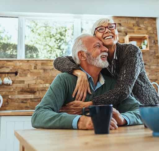 happy hugging older couple