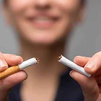 closeup of a person breaking a cigarette