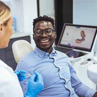 man smiling in the dentist chair about to have a checkup