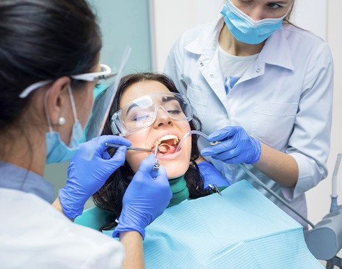 Woman smiling during dental cleaning