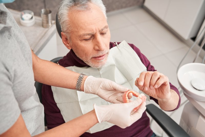 Man getting dentures at the dentist